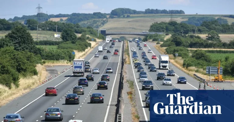 Cars queue at a petrol station as fuel prices rise before the bank holiday weekend